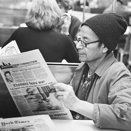 Felipe Quirós-Pérez reading yesterday's paper in a booth at Rennebohm's on State Street.